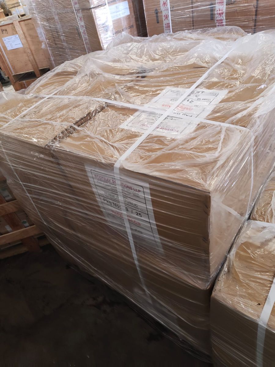 Ecotray cartons shrink-wrapped and strapped on a pallet at the export warehouse