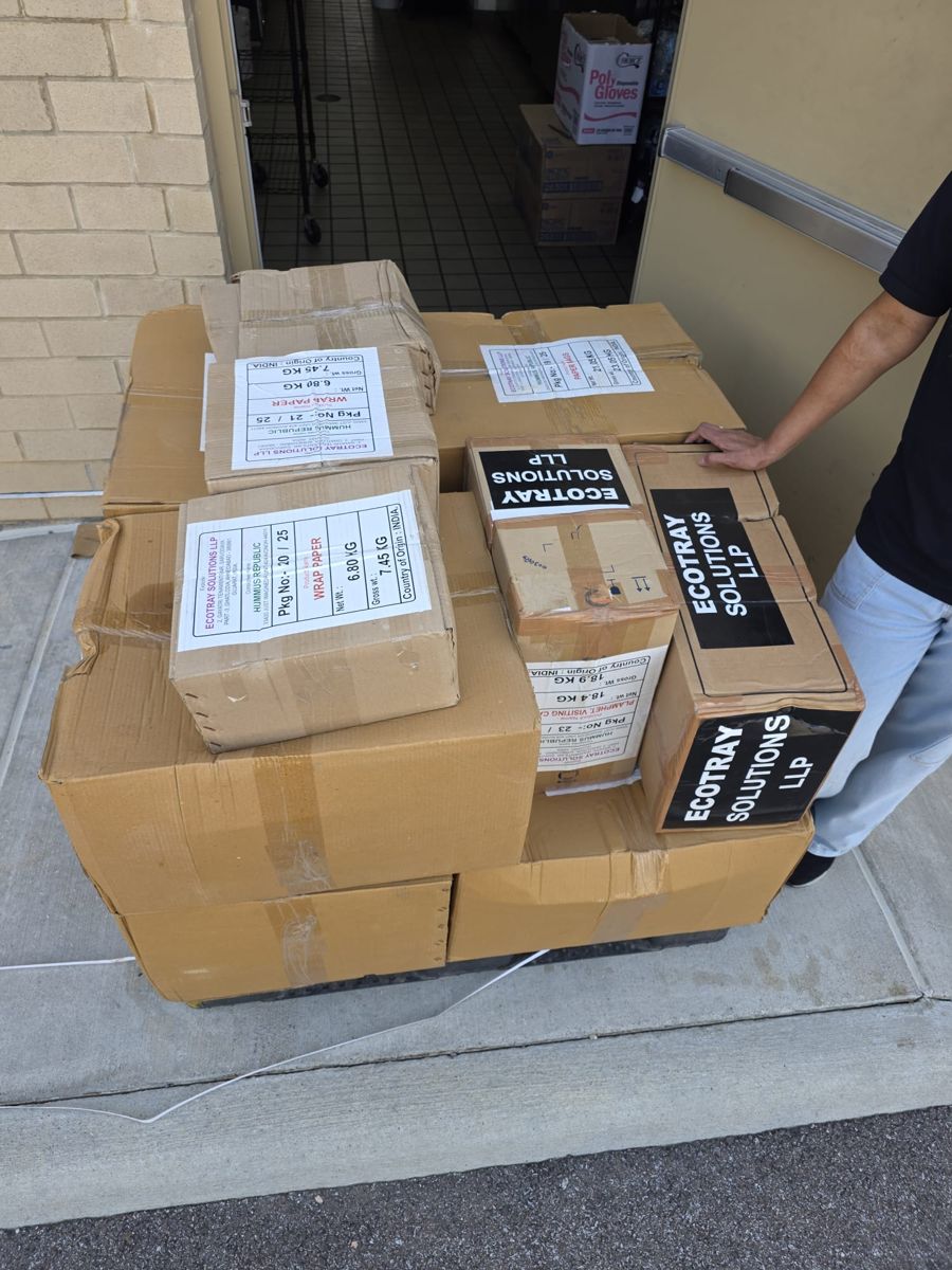Ecotray Solutions branded cartons at the restaurant back door